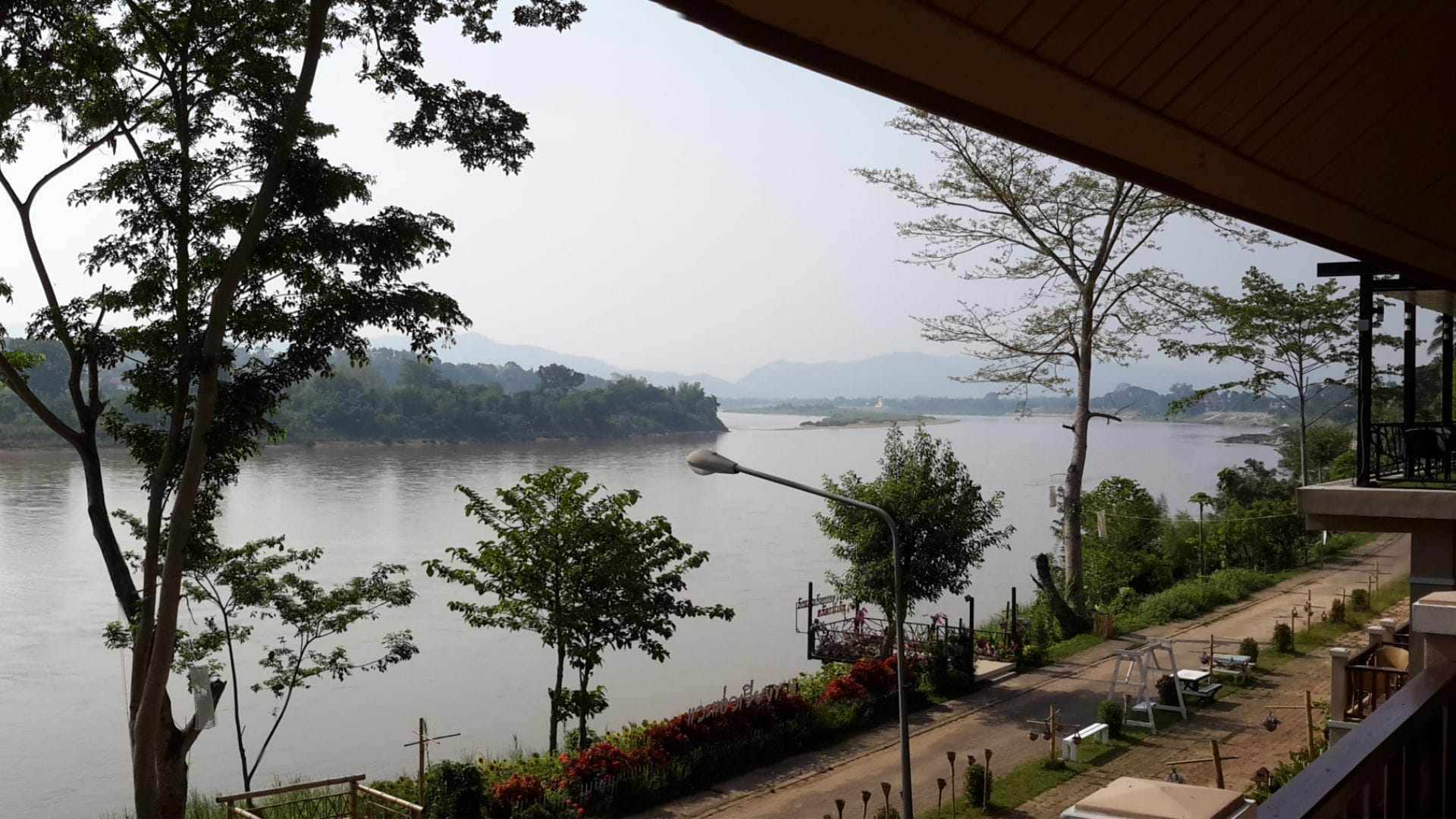 Scenic view of the Mekong River and surrounding greenery in Chiang Khong, Thailand.