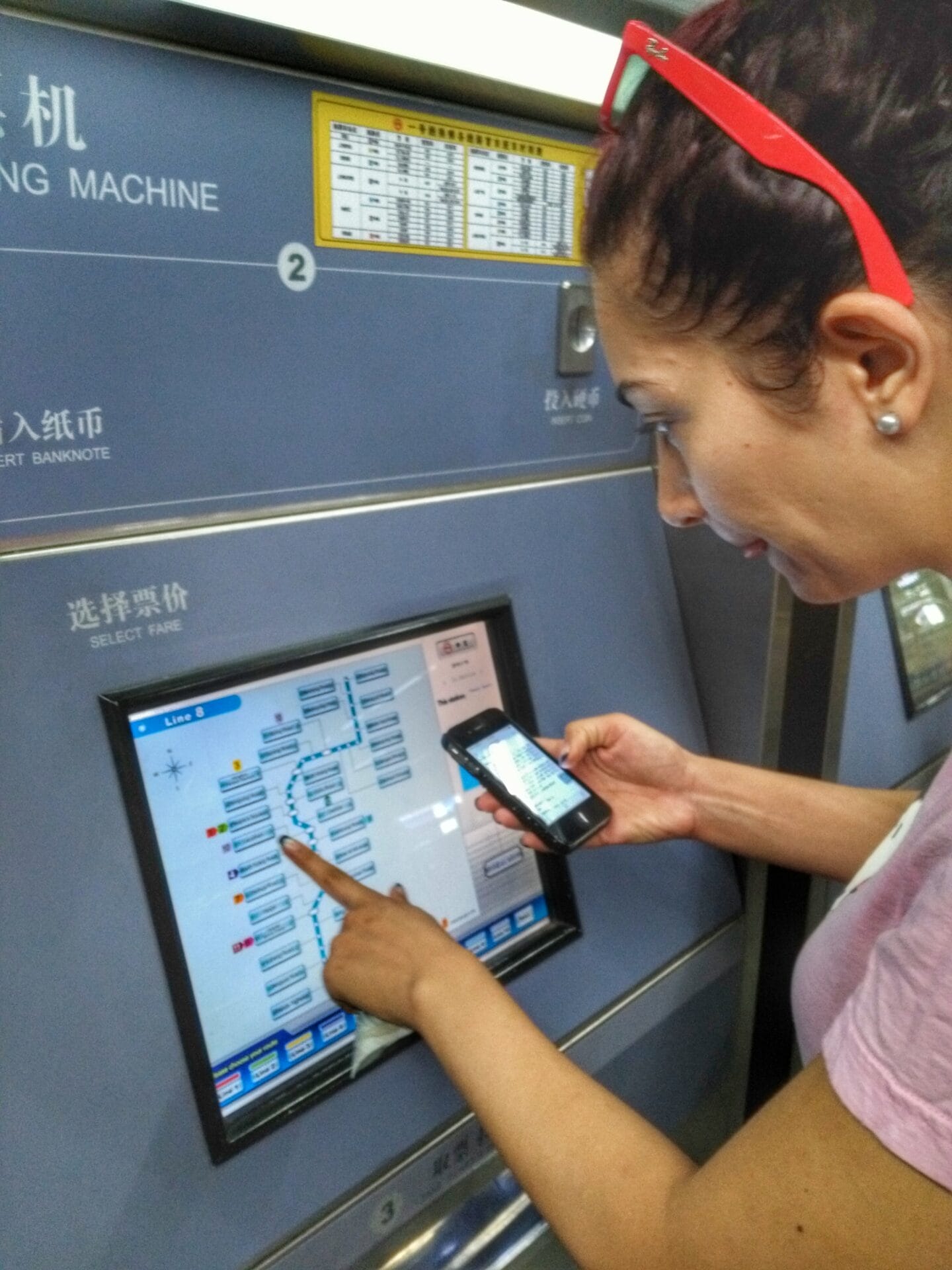 A person using a metro ticket vending machine at the Shanghai Metro, Shanghai, China.