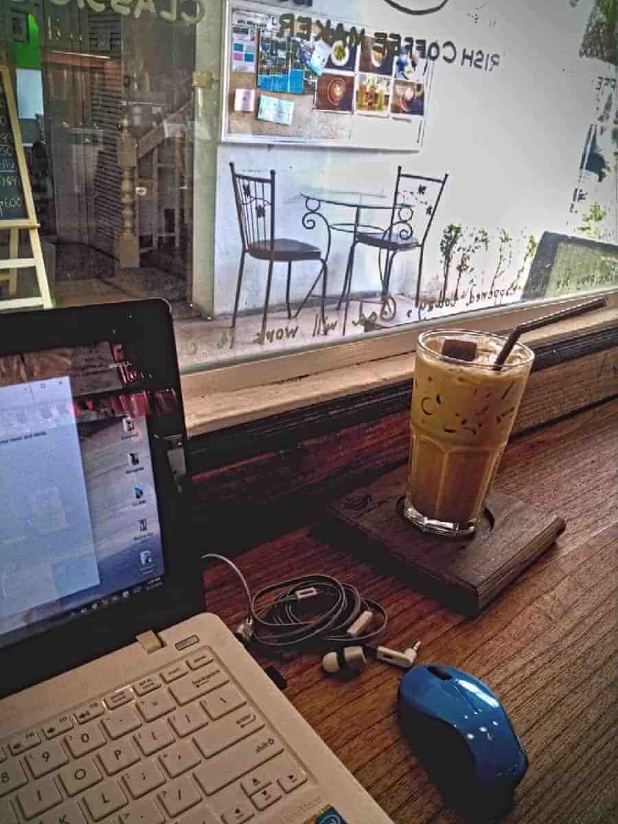 Chiang Mai versus Bali  - working on the laptop in a cafe in Chiang Mai, Thailand
