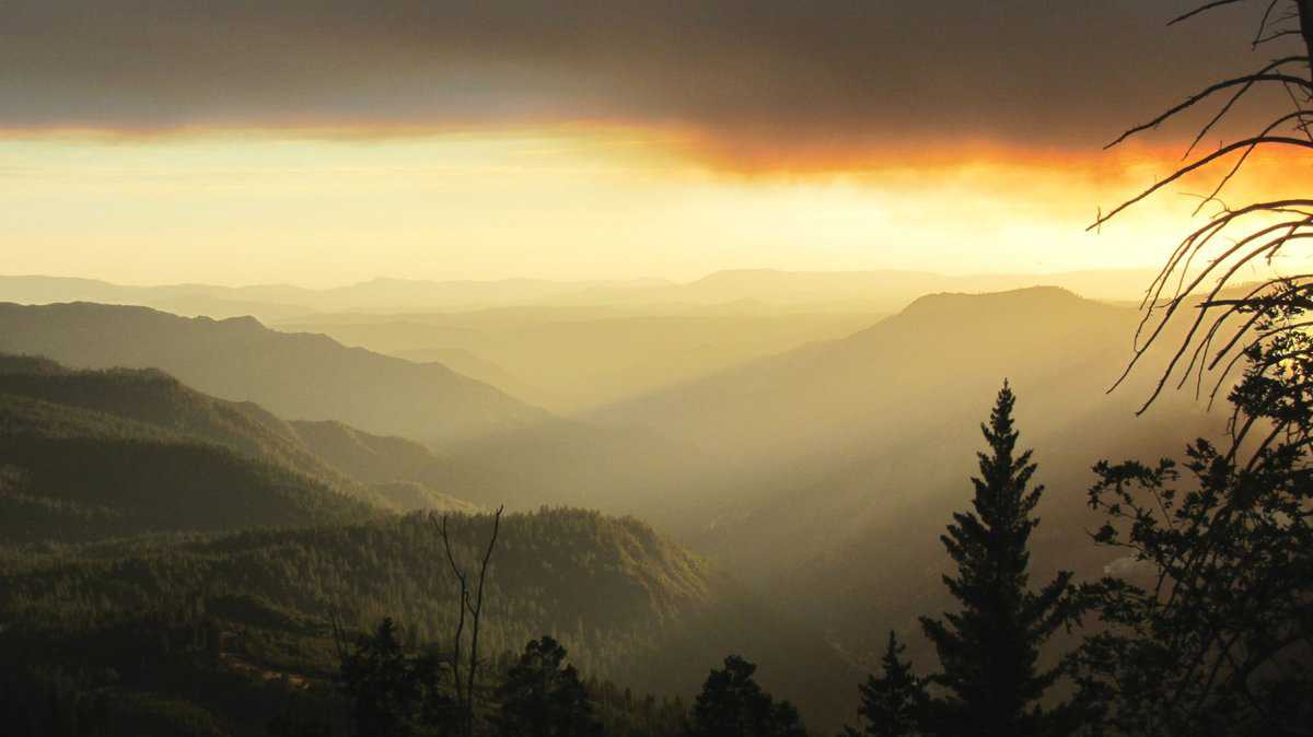 View of misty mountains at sunrise from Big Oak Flats Vista Point in Yosemite National Park