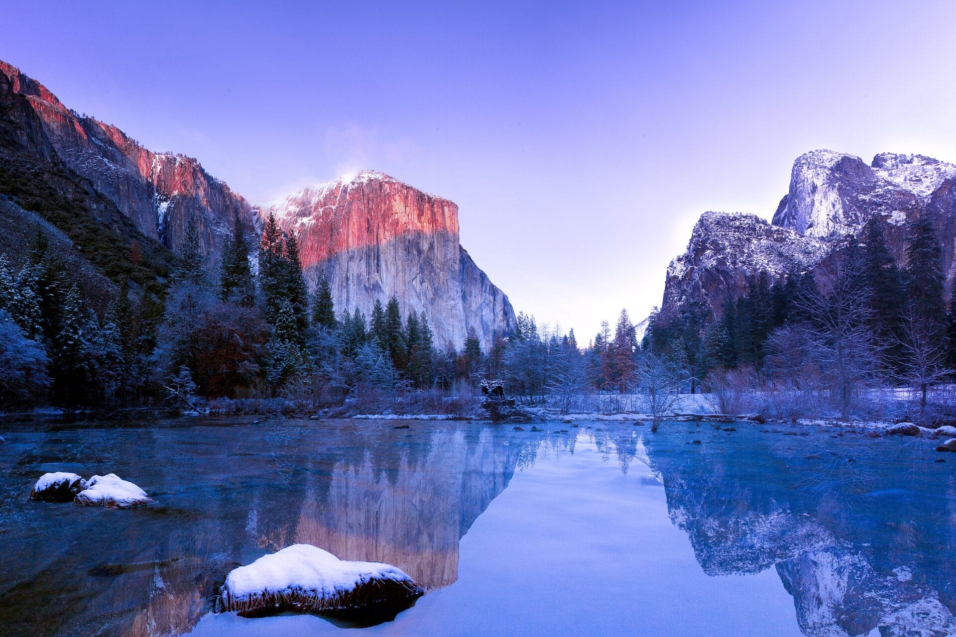 Valley View at sunrise in Yosemite National Park with El Capitan and Cathedral Rocks reflecting in the Merced River.