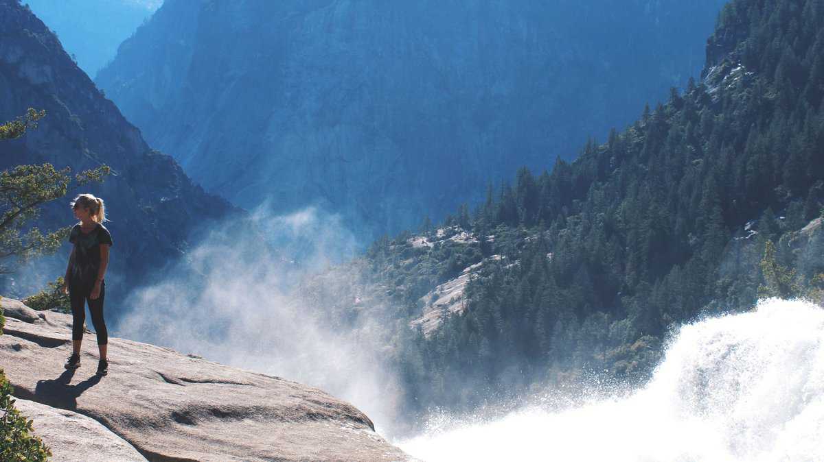 hiking next to waterfall in Yosemite