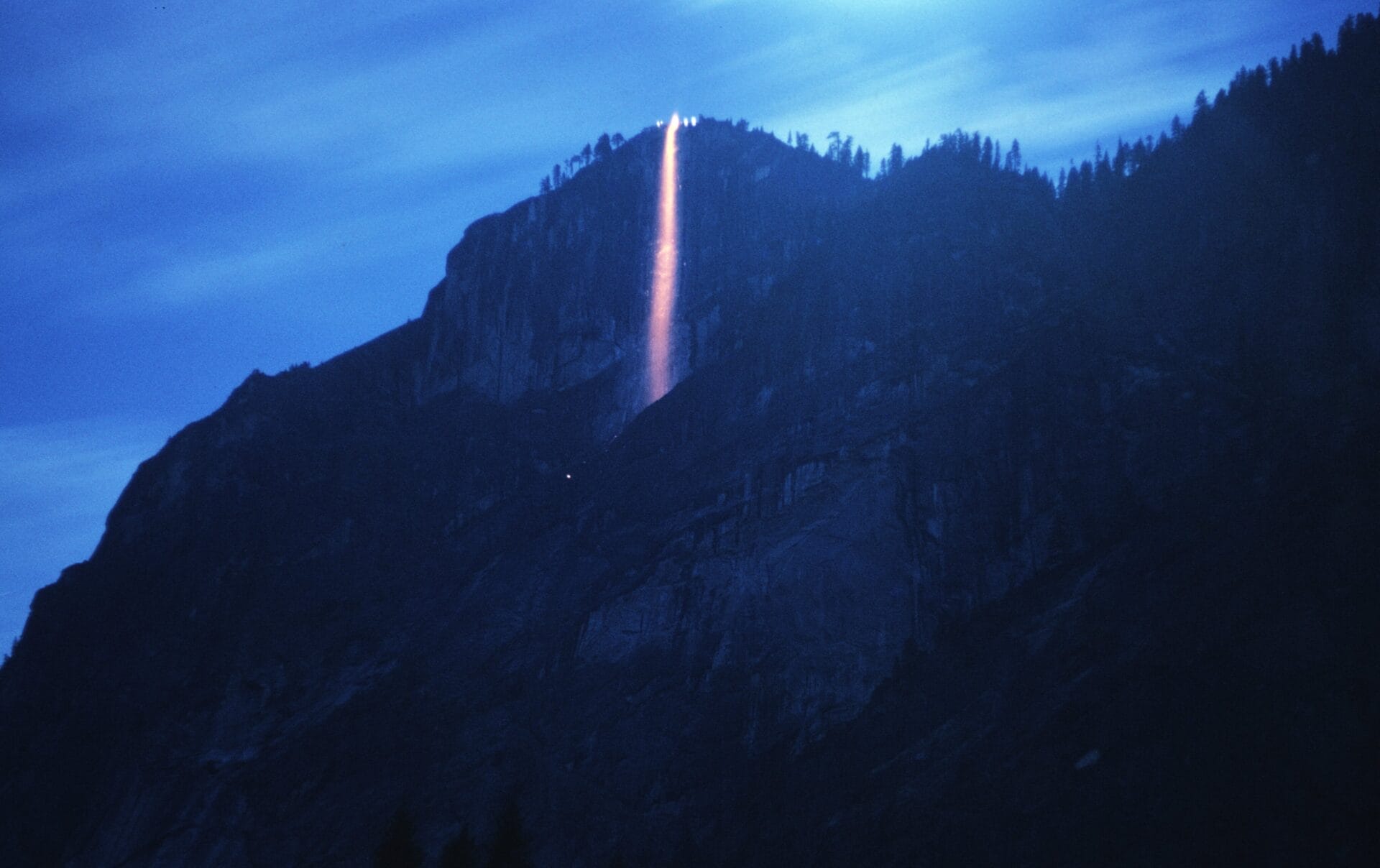 A stunning view of a glowing waterfall at twilight in Yosemite National Park.