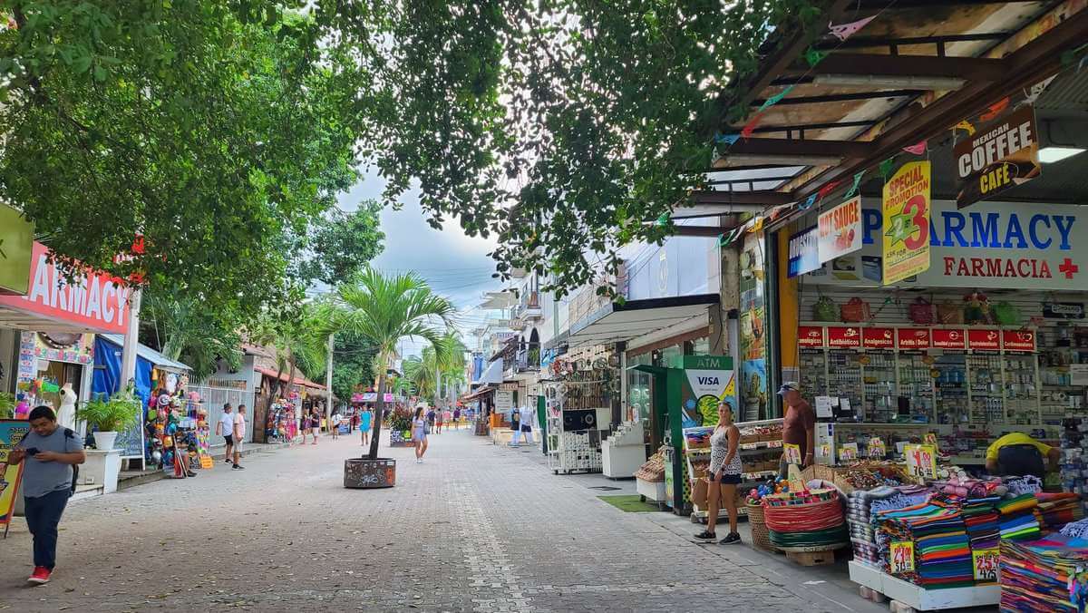 Bustling street with shops and pedestrians on 5th Avenue in Playa del Carmen, Riviera Maya, Quintana Roo, Mexico.

