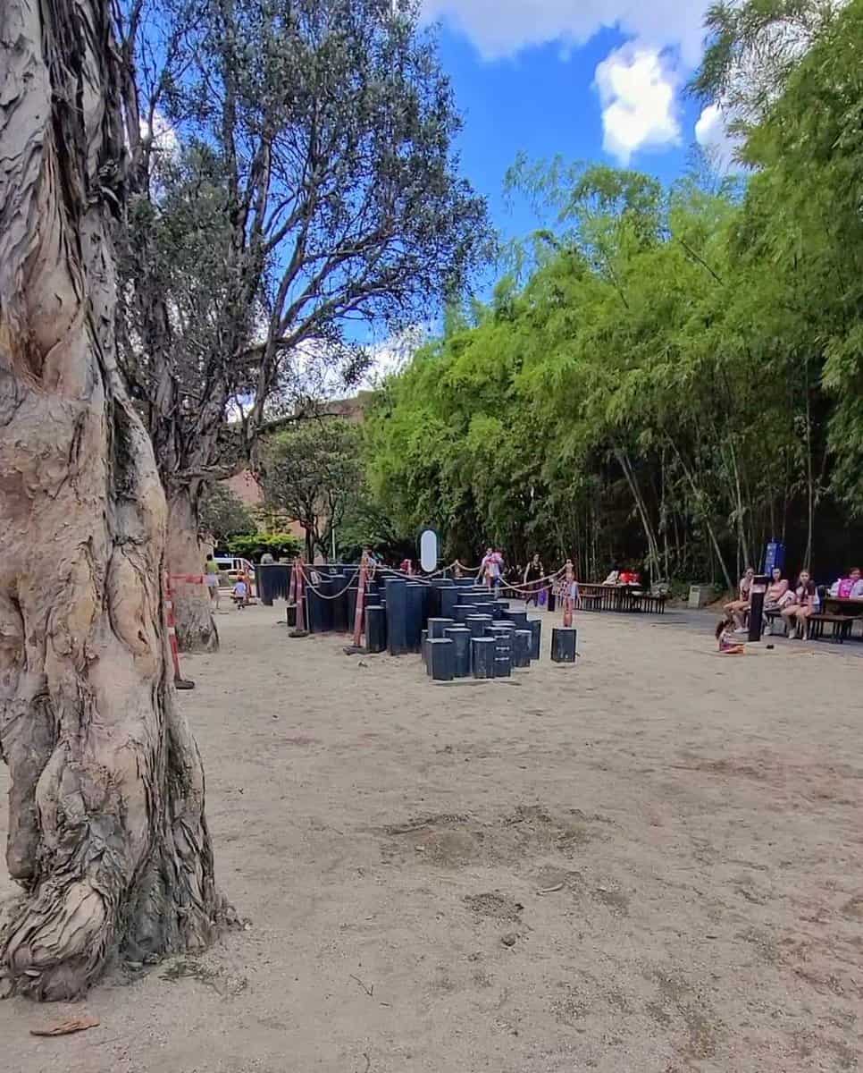 Visitors enjoying the outdoor ambiance at Parque de los Pies Descalzos (Barefoot Park) in Medellin, Colombia.