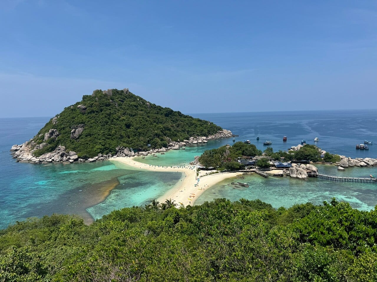 Aerial view of Koh Nang Yuan showing a sandy beach connecting it to Koh Tao, with emerald and turquoise waters surrounding the islands.
