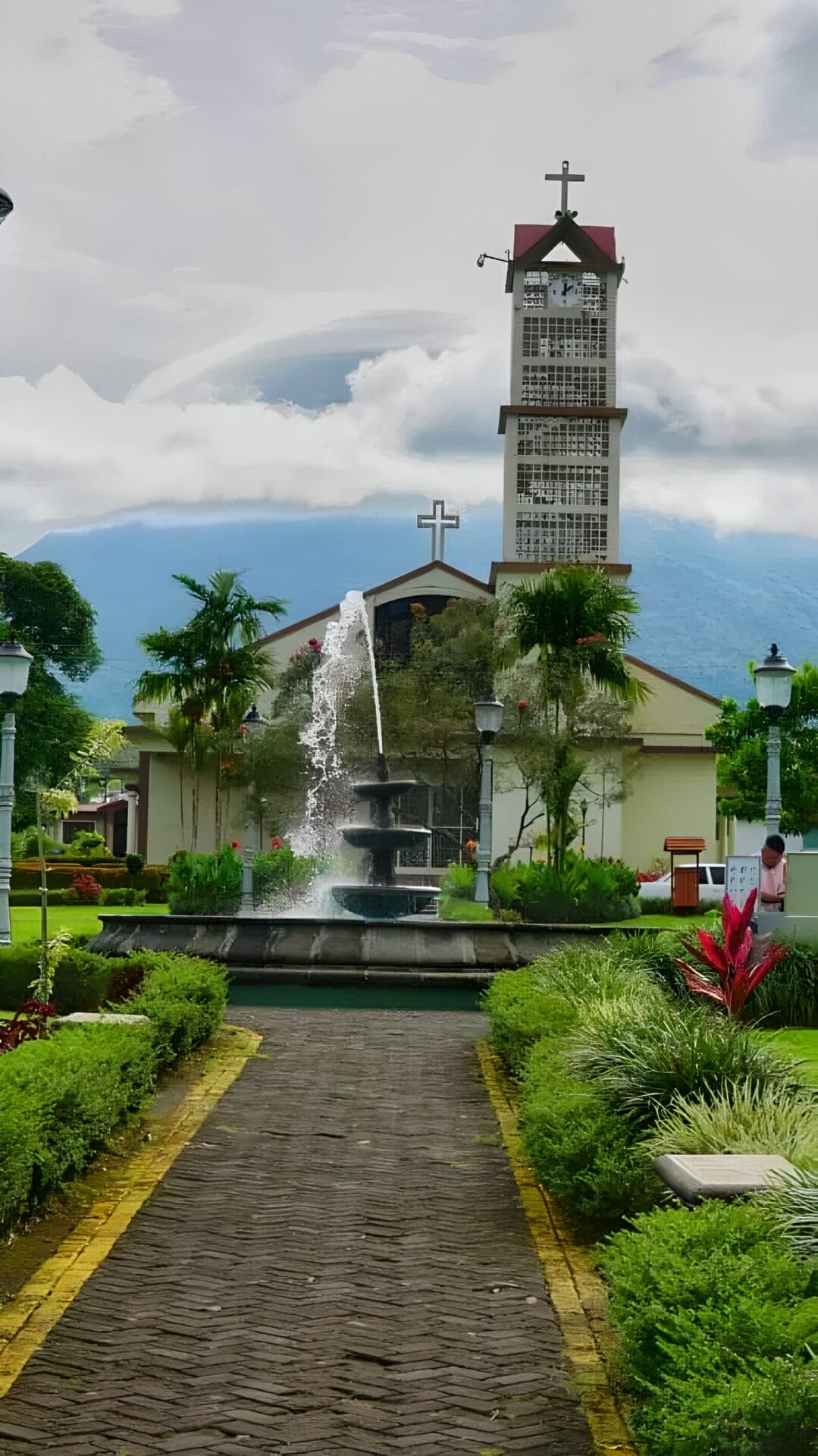 La Fortuna Costa Rica- Volcano view Central church and fountain in La Fortuna, Costa Rica, with Arenal volcano in the background.