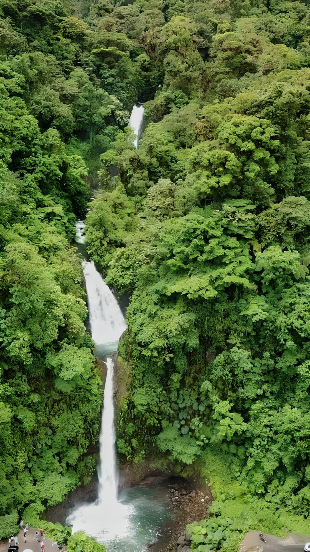 La Paz Waterfall - Costa Rica Must See Aerial view of La Paz Waterfall Gardens in Alajuela, Costa Rica, showcasing a series of cascading waterfalls surrounded by lush, dense greenery.