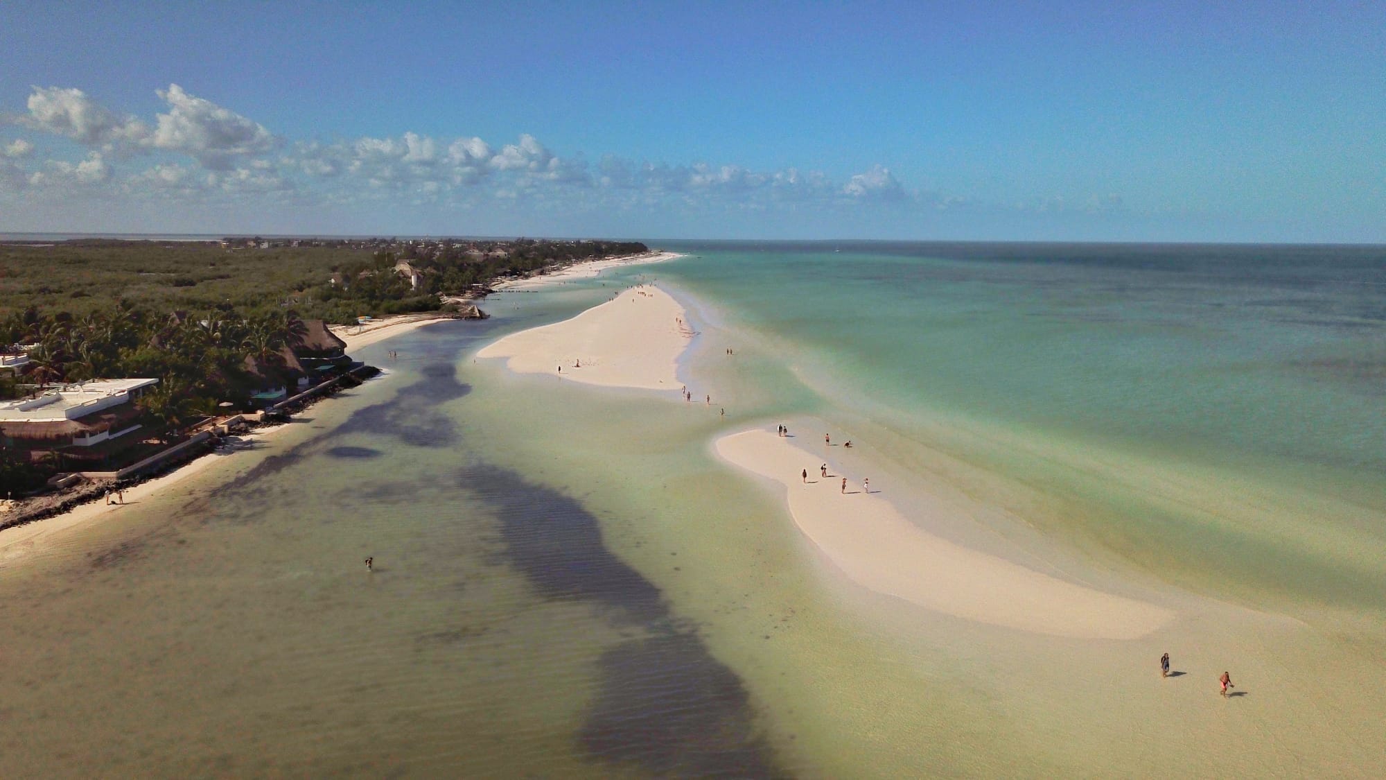 Aerial view of a sandy beach and turquoise waters at Isla Holbox, Mexico