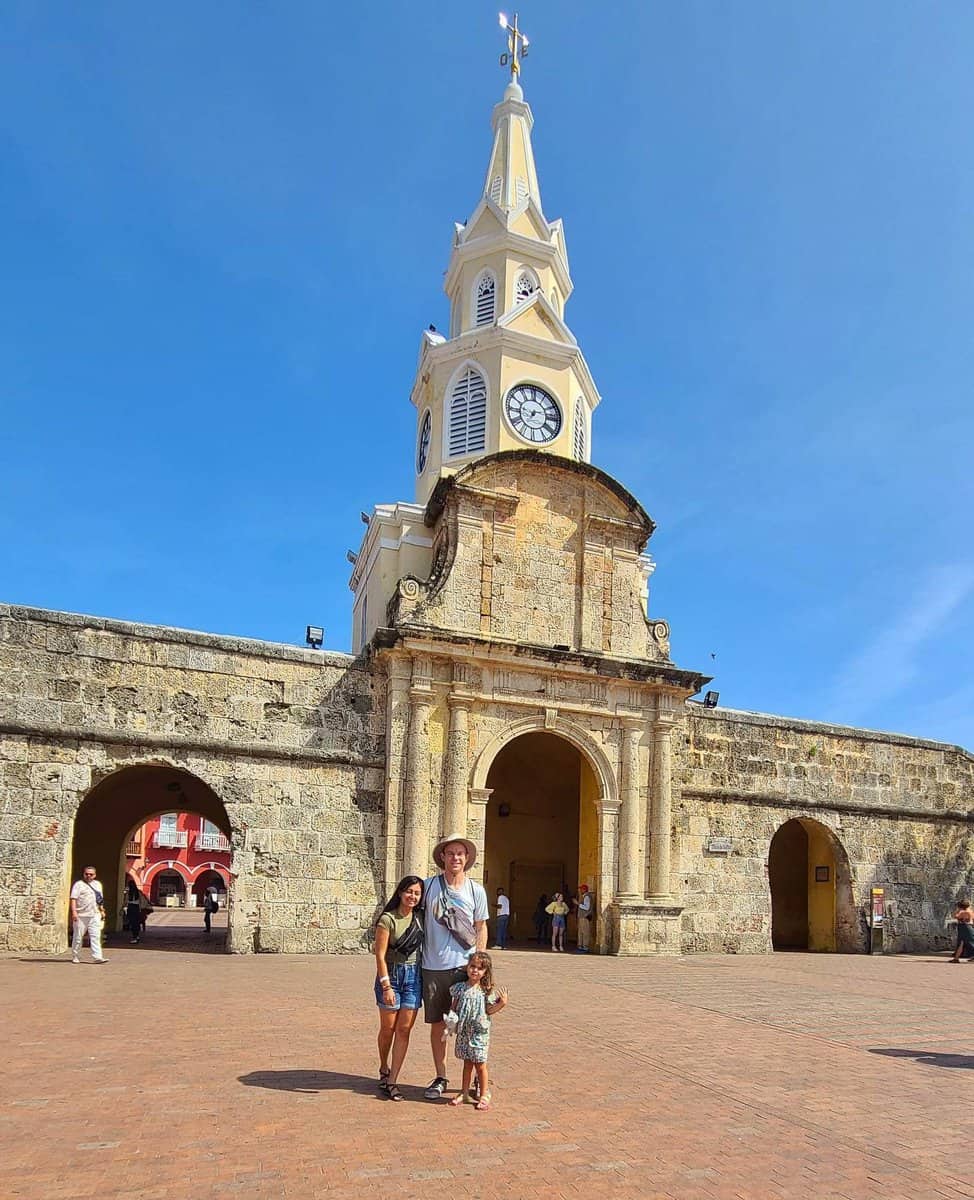 A family standing in front of the historic Clock Tower in Cartagena, Colombia.