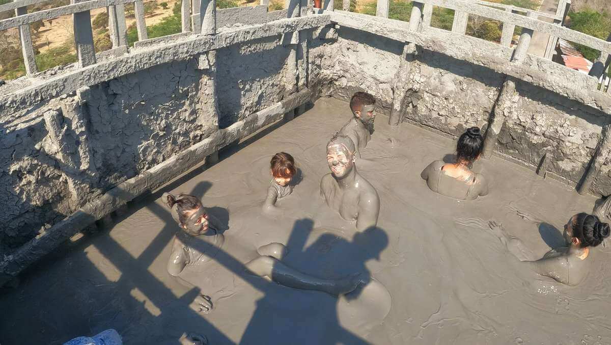 People enjoying a mud bath in El Totumo Mud Volcano near Cartagena, Colombia.