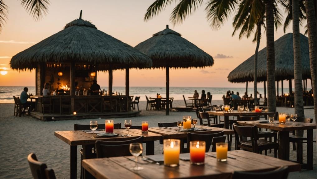 Beachside restaurant with tiki huts at sunset in Tulum, Mexico.