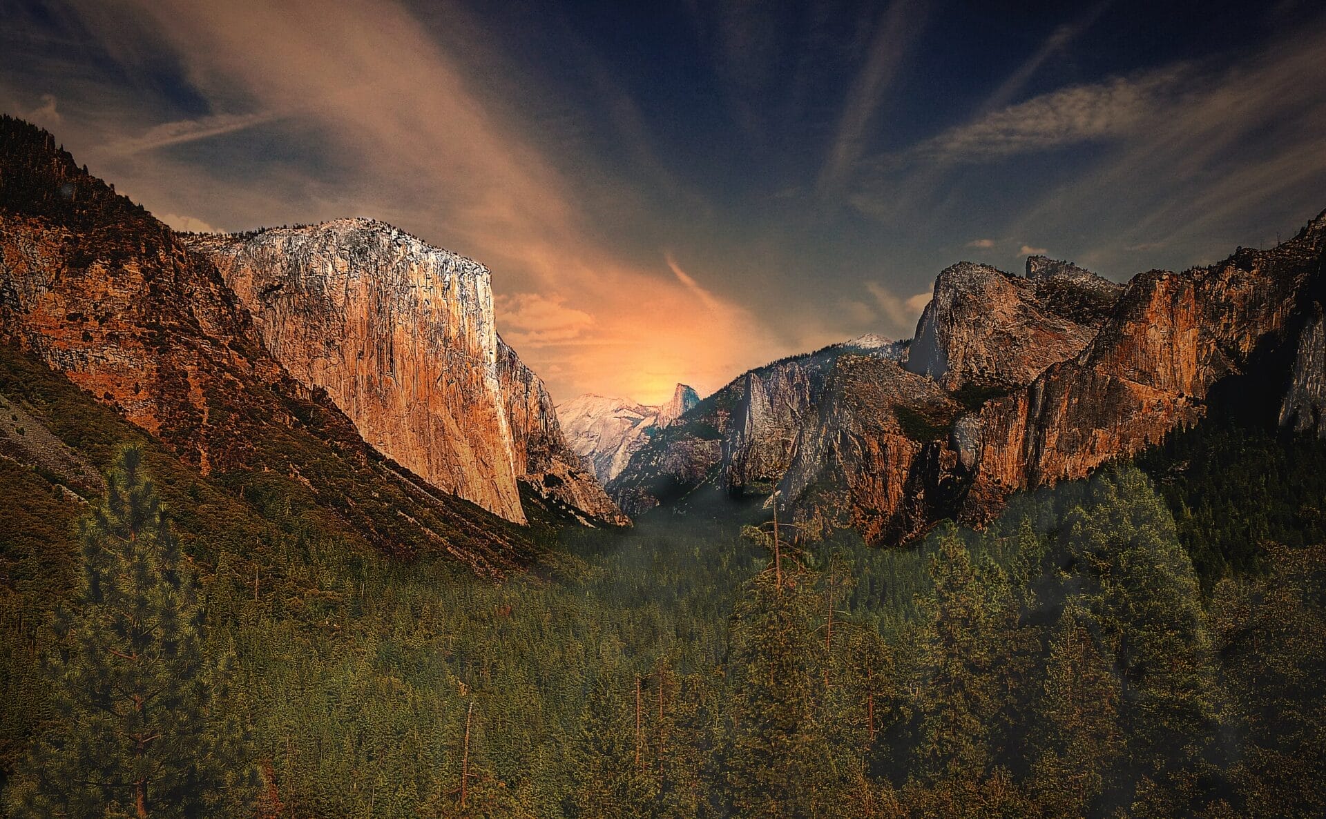 Tunnel View at sunset in Yosemite National Park showcasing towering granite cliffs and a vibrant sky.