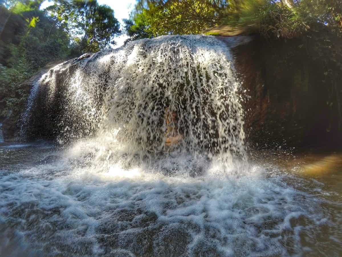 Mae Sa Waterfall cascading over rocky ledges surrounded by lush greenery in Chiang Mai, Thailand.